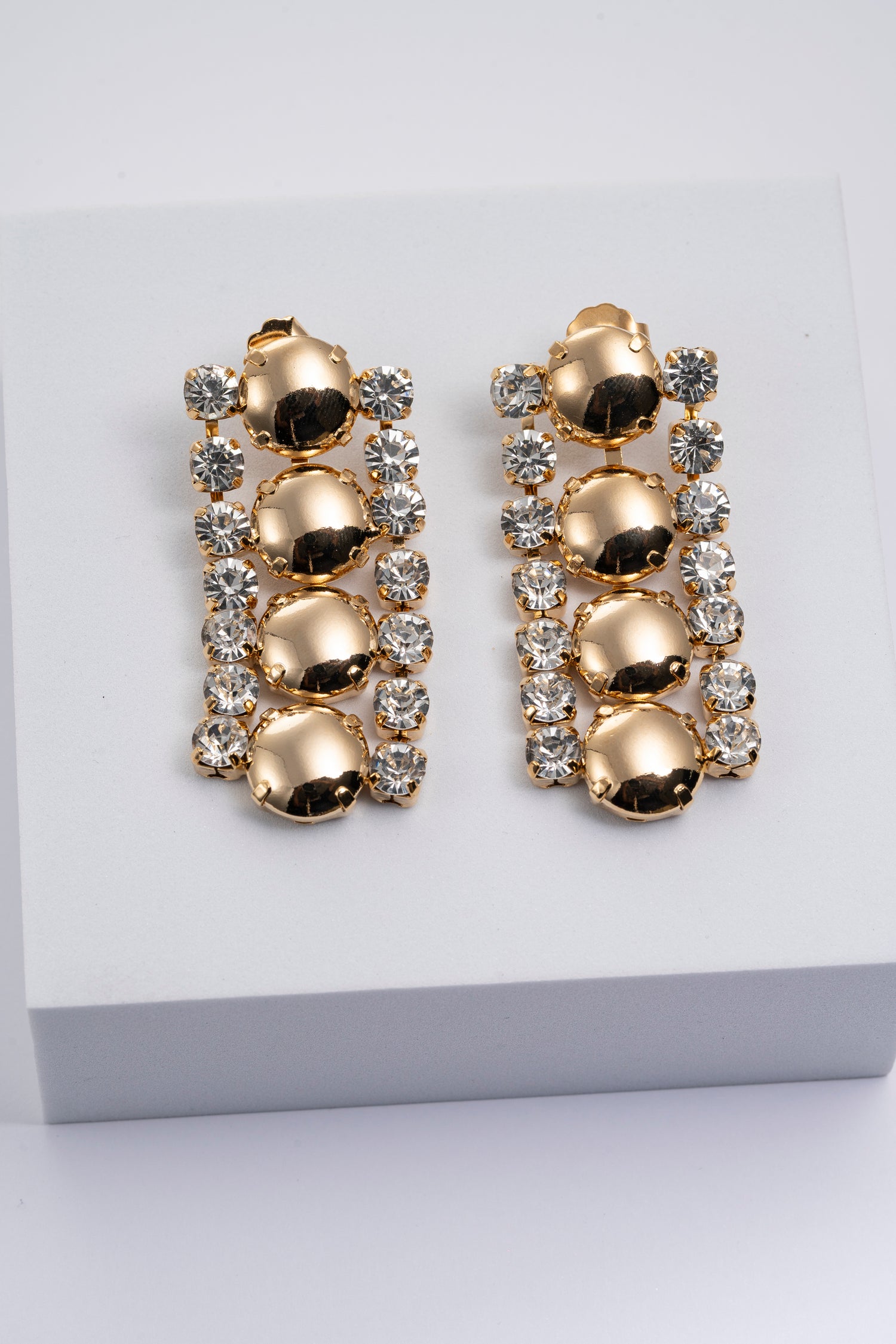 Orecchini dorati con cristalli luminosi Polaris